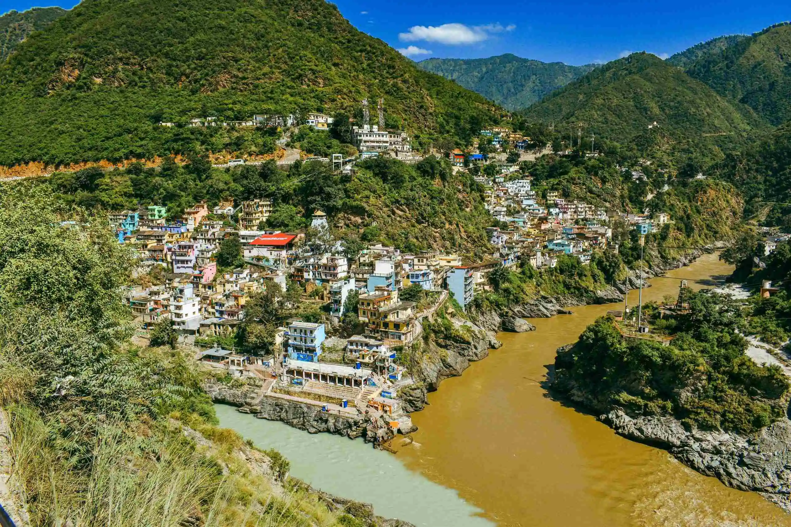 A breathtaking aerial view of the vibrant town of Devprayag at the convergence of rivers Alaknanda and Bhagirathi.